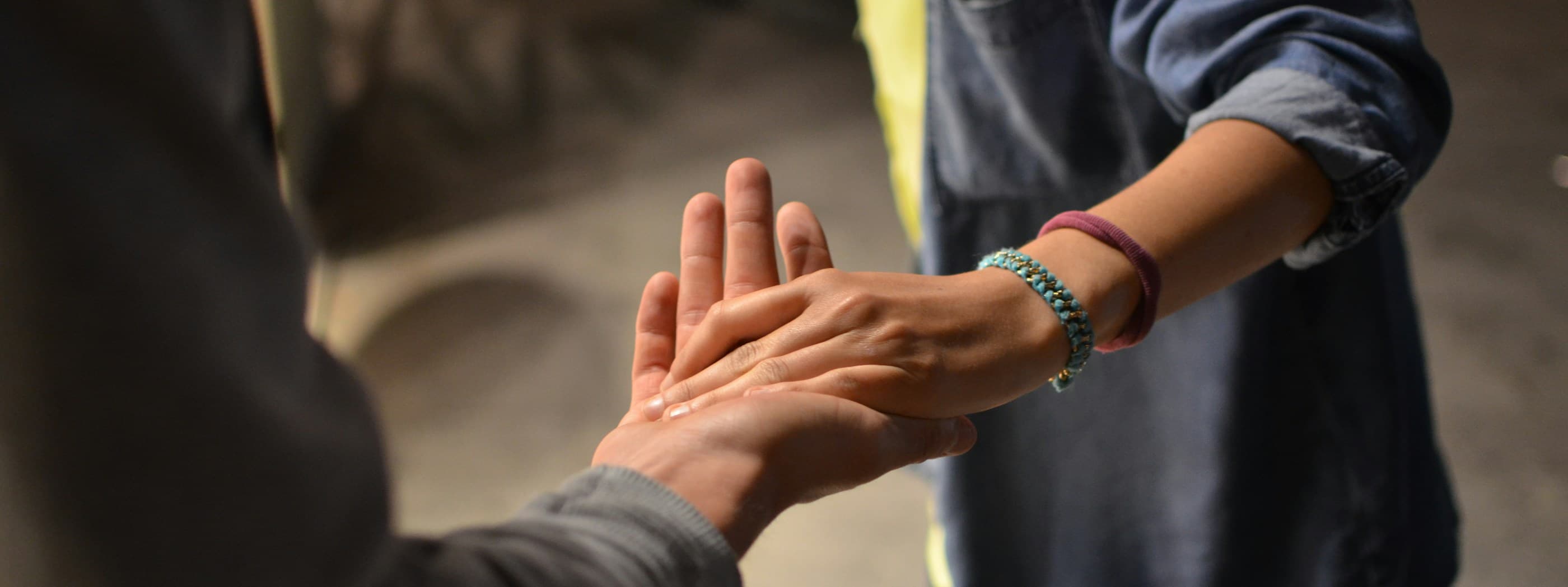 Two hands reaching out to meet palm to palm